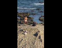 Man in white underwear poses at the beach at sunset