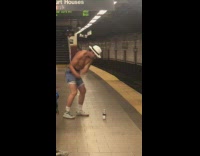 man golfs using stick and empty water bottle