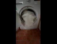 White blanket spin inside open washing machine