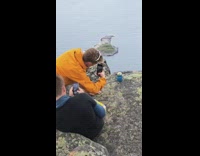 Guy orange jacket beer mountain ocean islands