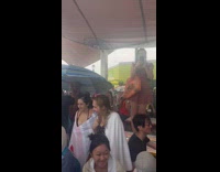 Lots of people take shelter from rain beach