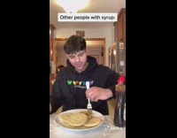 Guy pours bucket of syrup onto waffles 