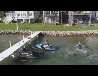 Woman behind jet ski gets splashed by the water
