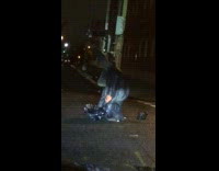 Homeless person does headstand on street