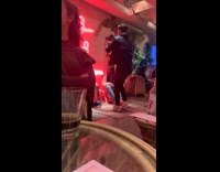 Guys record video in busy restaurant 