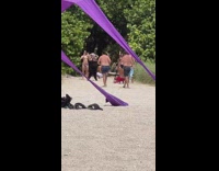 Two women bikini dance beach purple tent