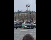 Two women bend knee middle of street