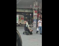 Man in scooter wears michael myers mask 