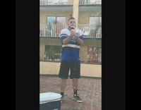 guy blue shirt drinking beer and belly flopping in pool