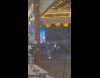 Woman bucket hat tiktok dance outside restaurant