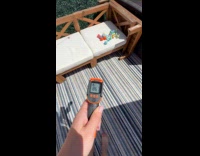 Submitter using temperature gun to check climate
