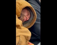 Collab Subway Creatures - Man orange hoodie sleeps in train lean sideways