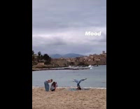 Woman headstand yoga spread legs beach mood