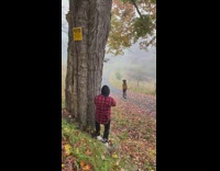 Guy photographs black hat girl walking street