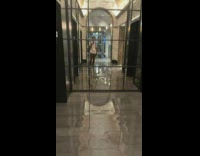 guy shows flooded hallway next to elevators