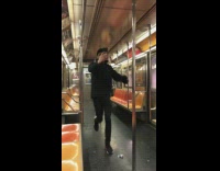 man in black hoodie runs through empty subway train 