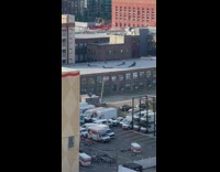 four people on roof walking with black blankets