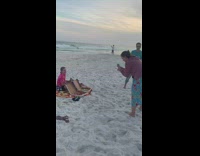 Woman pink shirt boxes of pizza photo shoot beach