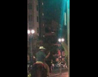 Guy ride horse cowboy hat street night