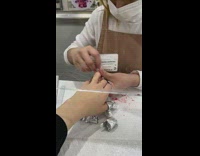 Worker at nail salon filing nails with a card 

