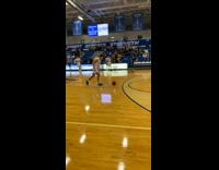 Guy kicks basketball up from behind and then dunks it