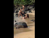 Two women in bikini beach photo near crowd