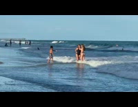 Kid two ladies black bathing suit beach