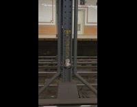 Stuffed animal on support beam in subway station