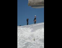 Woman carried by shirtless man on the snowy mountain