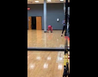 Woman squat exercise with phone inside gym