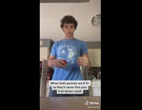 Guy hides blue shirt hides fruit stickers under shelf cabinet