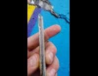 Guy holds layers of chipped paint skatepark 