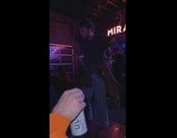 Guy standing on a small podium at the club dancing in slow motion 
