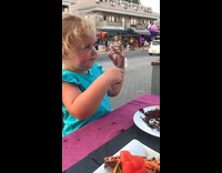 Little girl enjoys pudding on family trip