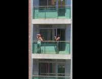White dress girl balcony shirtless guy 