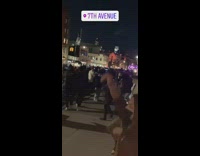 Group of people dance on sidewalk night 