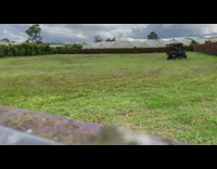 Guy goes on joyride on golf cart in grass field
