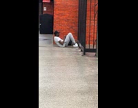 Man doing crunches at subway platform 