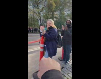 Woman fist bumps people watching marathon 