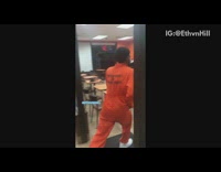 (BROKEN LINK) Guy in orange prisoner uniform walks into Dunkin Donuts hopes over counter and takes donut