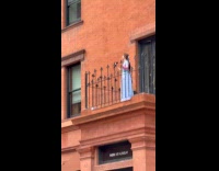 Woman mask dress sing on balcony street