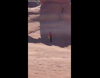 Guy selfie stick red yellow scarf arch 