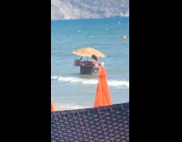 White bikini girl lays table in ocean 