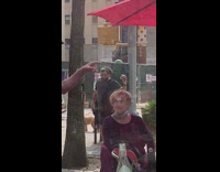 Black shirt guy photographs burger red umbrella 
