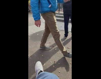 Guy recording another guy climbing water fountain while holding bone