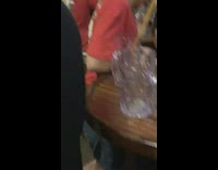 Drunk shirtless man kneels on bar table and falls off while singing angel song