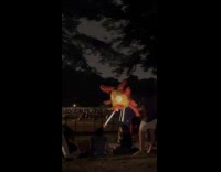 Spider head costume light cigarette at park