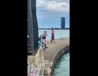 Woman violet shorts handstand biker ocean road