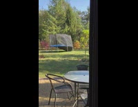 Man in a jacket hoodie jumps in the trampoline then it broke down