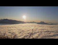 Clouds move with mountains and sun timelapse
